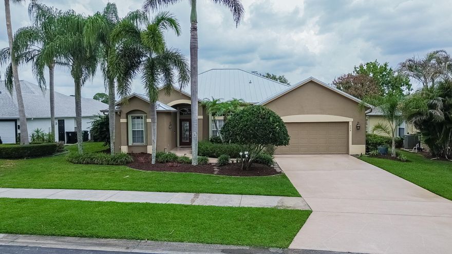 Enjoy stunning lake and pool views from the moment you enter this beautifully maintained 2003 CBS-built home in Crane Pointe, a gated community in Sawgrass Lakes. This 4BR/2BA split floor plan offers soaring ceilings, hardwood cabinetry, Corian countertops, newer appliances, accordion shutters throughout, and a 2-car garage. The spacious primary suite features a walk-in closet, shiplap accent wall, dual sinks, walk-in shower, and jetted tub. Outdoor living shines with a large screened lanai, sparkling solar heated pool with peaceful waterfall features, outdoor shower, and lush professional landscaping overlooking the lake. Additional updates include a 2023 metal roof and 2025 A/C. Low HOA dues, central location, and boating access to interconnected lakes complete the lifestyle.