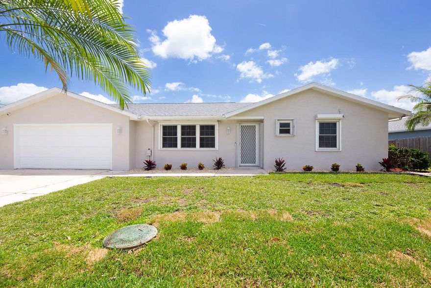 Beautifully renovated and move-in ready, this stunning home in Eastern Port St. Lucie offers the perfect blend of comfort and convenience, just minutes from shopping and beaches. Freshly painted inside and out, it features a brand-new roof, new laminate flooring throughout, newer stainless steel appliances, and updated fixtures. The spacious owner's suite highlights a gorgeous, newly renovated en-suite with dual sinks and a custom shower. Enjoy the bright Florida room overlooking a large backyard with plenty of room for a pool. Additional highlights include brand-new irrigation, an extended driveway, gutters, partial automatic storm shutters, and fresh landscaping—truly a must-see!