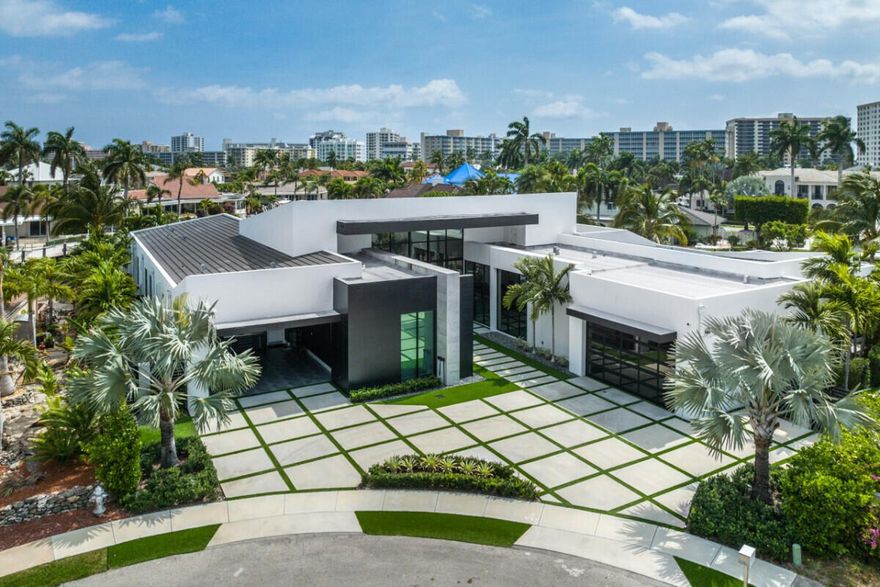 Incredible opportunity to own this modern ONE STORY masterpiece beautifully designed by award winning Affiniti Architects. This 8361 sqft home offers 5 bedrooms, 5/2.5 bathrooms, theater, , club room, two separate 2 car garages and 240 ft NEW seawall on a deep water canal. From the moment you walk in you'll be welcomed by the natural lighting, open floor plan, immediate views of the infinity pool and canal. The open flow of this home creates amazing transitions from the Living room, Dining room, Club room, Florida room and Kitchen all grand in size - making this the ULTIMATE home for entertaining!