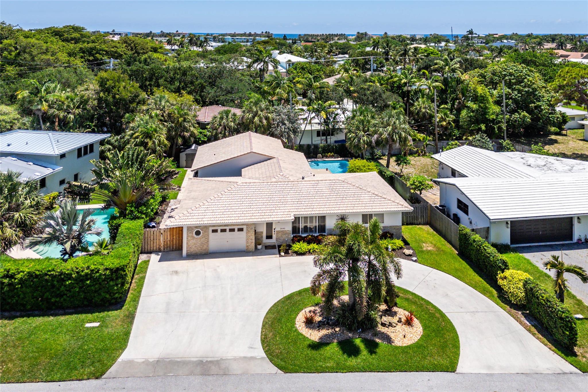 Welcome to an inviting haven nestled in the marina area of Lighthouse Point. This home offers 4 beds/2baths which includes a converted garage that can function as an office/gym, playroom or extra bedroom. Natural light floods through the impact windows/doors and the updated kitchen is a testament to both style and functionality. The private primary retreat is thoughtfully situated away from the other bedrooms, 2 living spaces plus a dining room allow versatility. Outside the tropical oasis features a covered patio that overlooks a lush backyard, complete with a sparkling pool. This outdoor paradise offers ample space for play, gardening, or simply lounging in the Florida sunshine. Lighthouse Point is a vibrant neighborhood offering restaurants, shopping & parks just a stone's throw away!
