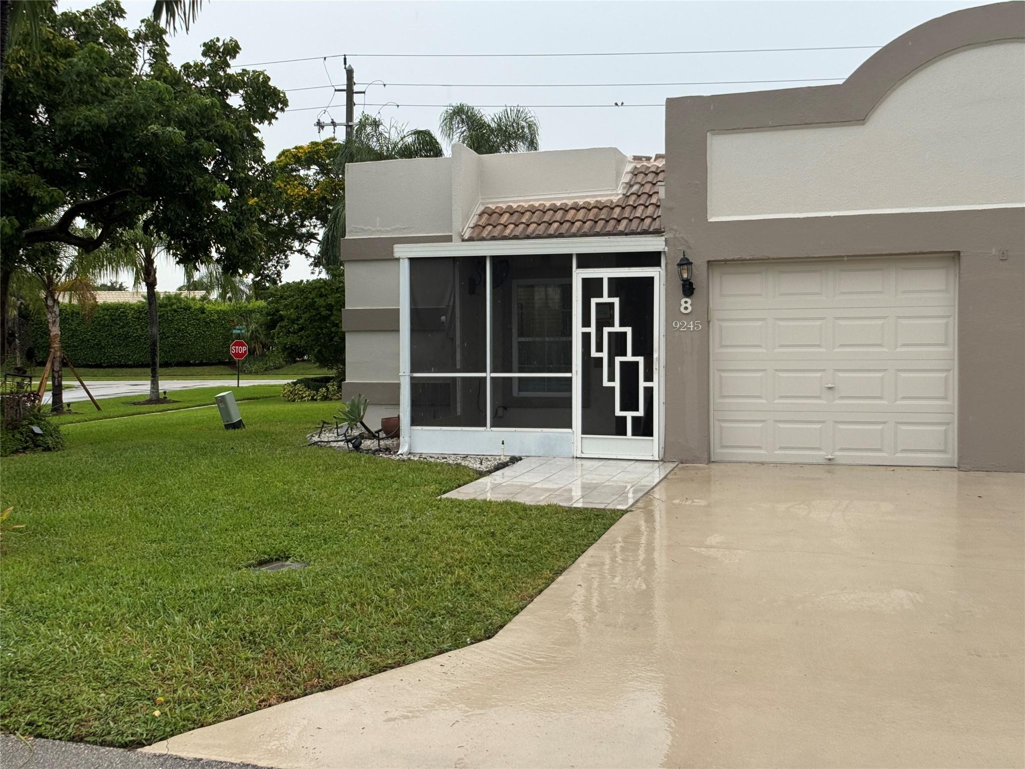 PRICED TO SELL! Well maintained 2/2 CORNER Villa in a very active over 55 community of Town Villas. Beautiful cherry wood kitchen cabinets, 1 car garage, enclosed front patio, updated kitchen, granite counter tops. Title throughout. Short walk to clubhouse with heated pool, tennis and bocce courts, game and exercise rooms, etc