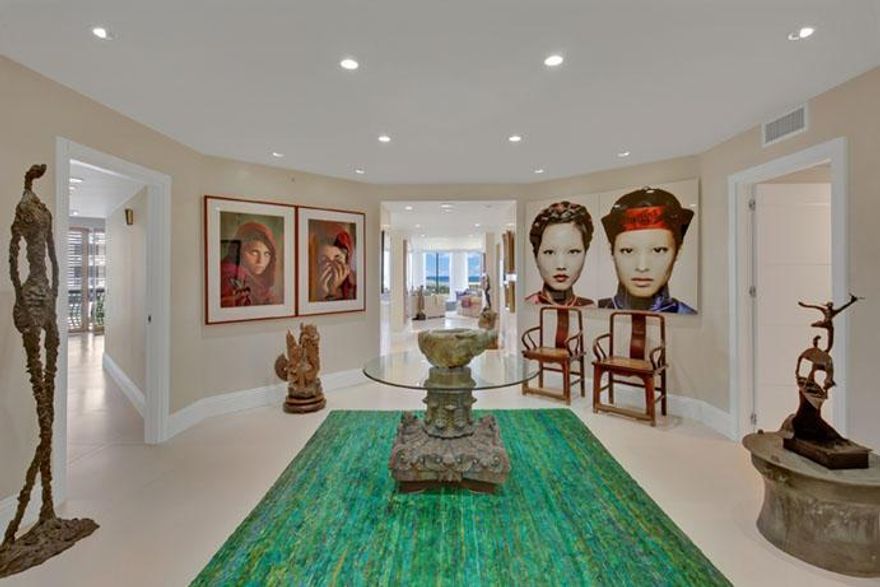 Spacious, bright, state-of-the art, all describe this outstanding condo on the ocean. Upon entering, you will be taken by the direct views of the ocean. Start your day watching the sunrise over the waves of the Atlantic from your private Oceanside patio and relax at the end of the day while watching the sunset over the Intracoastal from your wrap around balcony. With walls of floor to ceiling glass hurricane impact doors throughout, light pours into this fully renovated home. This kitchen is a work of art with high gloss custom cabinetry from Italy. In the great room, conversation and company easily flow between the living and dining areas. This unit has two master suites both with gorgeous ocean views!  Direct access to the beach without going through the building, lives like a home.