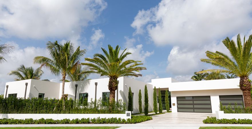 Experience luxury living in this custom one-story home on a +/-17,000 sqft lot on this Intracoastal, east of Olive Ave block. This contemporary masterpiece features 3 bedrooms in the main house, plus a separate guest cottage for added versatility. As you enter, you'll be greeted by exquisite cypress ceilings and soaring ceilings that create an open, airy atmosphere. Enjoy resort style living with a large, heated pool. Car enthusiasts will appreciate the 3-car garage. Designer finishes and clean lines throughout add a touch of elegance. Entertain and dine al fresco in the covered loggia with a summer kitchen. Additional features include, Outdoor shower, covered loggia with retractable electric screens and private sitting room off of the primary suite.