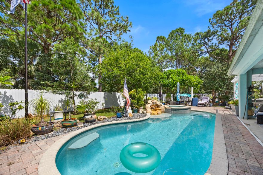 Resort style living meets everyday comfort in this beautifully updated 3 bedroom, 2 bath home. Enjoy a salt water pool with spa plus a separate 6 person Jacuzzi perfect for entertaining or unwinding. The 8ft fence surrounds the backyard for optimal privacy. Inside, wood plank tile floors, plantation shutters, and hurricane impact windows create both style and security. The fully renovated bathrooms shine, and the kitchen features new appliances ready for your next culinary adventure, especially with the free standing range with double ovens!  A 2020 metal roof and thoughtful layout add peace of mind. All this in a fantastic neighborhood close to shopping, dining, and more! Additional lots are also available for sale MLS# RX-11126426 & RX-11126423. Each lot is .23 of an acre.