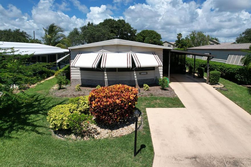 Spacious 2 Bedroom 2 Bath manufactured home on owned land in the 55+ community in Hobe Sound.  Beautifully re-done coastal chic and comes totally  furnished with  everything you need to move in and start your fabulous Florida lifestyle.. The Floor Plan is open with a Formal dining Area, large Living Room and very spacious Family Room., For even more space – a large, screened lanai with a Laundry Room and work room attached.  Fenced yard for all your pets!  Two large bedroom and baths.  The Master Bedroom Suite has a large cedar walk in closet. The home is minutes from beaches, shopping and entertainment.   Cambridge is an active 55+ community with Clubhouse, heated pool, shuffleboard, billiards and loads of activities.