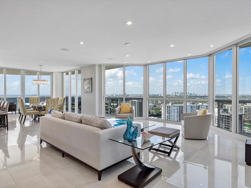 Enjoy breathtaking direct ocean, coastline, Intracoastal, and downtown views from every angle in this stunning high-floor double-corner unit at the Carlyle in L'Hermitage. This meticulously renovated residence offers a sophisticated blend of luxury and modern convenience, featuring high-impact windows, porcelain flooring, and an open-concept kitchen with top-tier cabinetry and appliances. The design layout includes extra closet space, a spacious laundry room, a den/third bedroom, and two expansive patio decks perfect for entertaining or relaxing. The unit also boasts private elevators, elegant glass front doors, a new A/C and water heater, a surround sound system, a smart thermostat, a smart lighting system, and a water filtration system. Pre-plumbing for wet bar in living room provided.