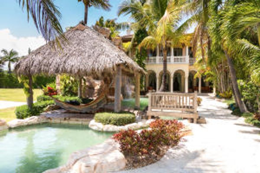 Perfectly situated on a beautiful waterfront lot in esteemed Lighthouse Point, you will find this breathtaking 5 bedroom, 8.5 bathroom Mediterranean-inspired, intracoastal home with 40 feet of private dock. Palatial in demeanor, this estate epitomizes Old World elegance and the finest of artisan workmanship. From elaborately carved woodwork to hand-painted European frescoes that grace the ceilings, this home exudes an air of integrity and quality rarely found today. Built by renowned Remi Developers in 2005, this waterfront paradise has left nothing to imagination. It is certainly one of a kind. It welcomes you from the moment you enter the private gates and walk onto the grounds accentuated by lush landscaping and fountains. As you enter through the arched, hand-carved mahogany doors foun