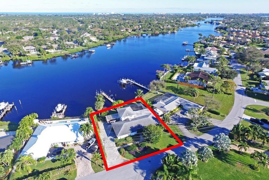 Tear me down or fix me up! Great opportunity on the Loxahatchee River! This property is situated within a gated community, close to 2 newly redesigned golf courses and features a newer seawall and eastern exposure.