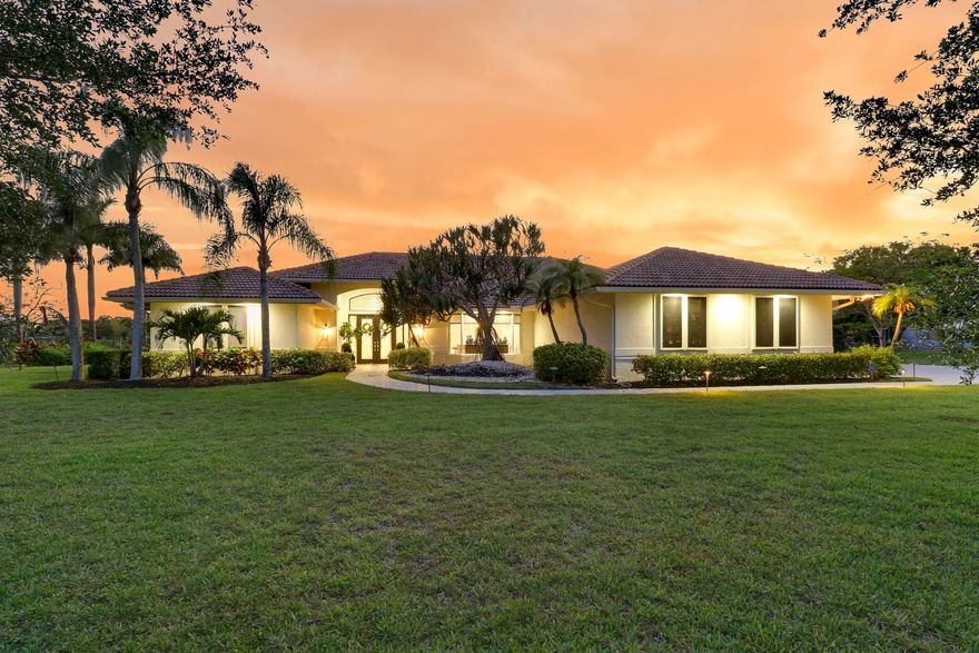 Newly offered custom estate home on 1.13 acres in the prestigious gated community of Steeplechase in Palm Beach Gardens. Completely remodeled in 2024, this exceptional luxury residence offers nearly 5,000 square feet of beautifully designed living space with 5 bedrooms and 4.5 bathrooms. Situated on one of the premier lots in the community, the home showcases breathtaking long water views with coveted western exposure, creating unforgettable sunset backdrops from the privacy of your backyard. Designed with both elegance and comfort in mind, the home features a spacious open-concept floor plan with soaring volume ceilings and abundant natural light throughout. The chef's kitchen is expertly appointed with custom finishes, premium appliances, and an oversized quartz  island that seamlessly flows into the main living areas—perfect for entertaining. The expansive primary suite is bright and inviting, complete with a spa-inspired en-suite bath and a large custom walk-in closet. Additional highlights include a desirable split-bedroom floor plan, modern designer finishes throughout, and beautifully updated amenities that elevate every aspect of daily living. This one-of-a-kind estate is a must-see for the most discerning buyer. Schedule your private showing today.