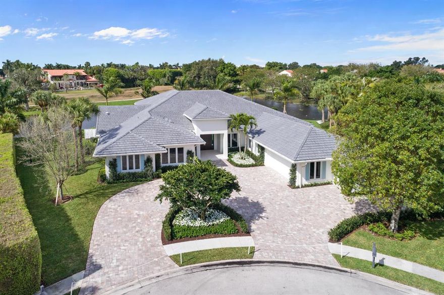 Elevated to the highest level of luxury and comfort, this unique property sits on a 3/4 acre lot and spans 290' of direct water frontage in the heart of Palm Beach Polo. Completely redesigned with the highest quality finishes throughout, this single-story residence features 5 bedrooms, 6 baths, office and state-of-the-art kitchen with Thermador appliances. Floor to ceiling windows and doors in all living areas lend to the airy aesthetic of the space, providing sweeping vistas of the Dunes Preserve and beyond. The oversized outdoor living area with retractable screens is superb for entertaining and provides a serene setting to enjoy the incredible Florida sunsets. Expanded circular motor court offers easy access to all garages and provides additional guest parking. Must see!