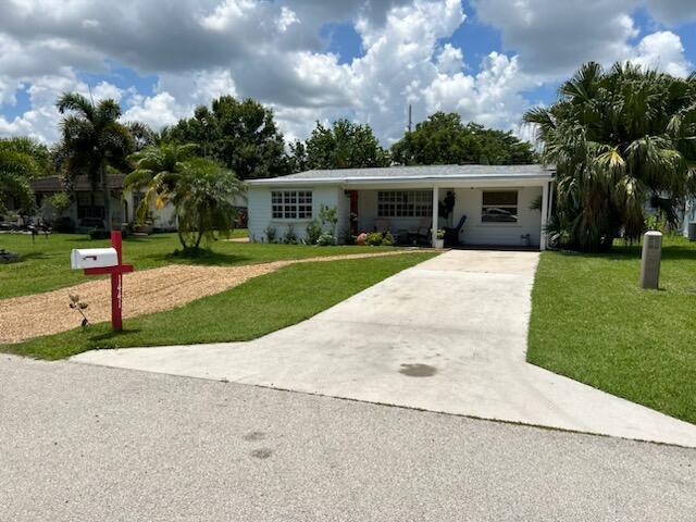 Great neighborhood CBS Home Located a stone's throw from the beach & Intracoastal and a bike ride to the ocean. Tropical paver patio for BBQs and outdoor gatherings. 2nd Bathroom off the kitchen accessible to outside area. This would be a fantastic primary or second home for anyone. Very well maintained, in sought after area with city utilities, Low Taxes and NO HOA dues.