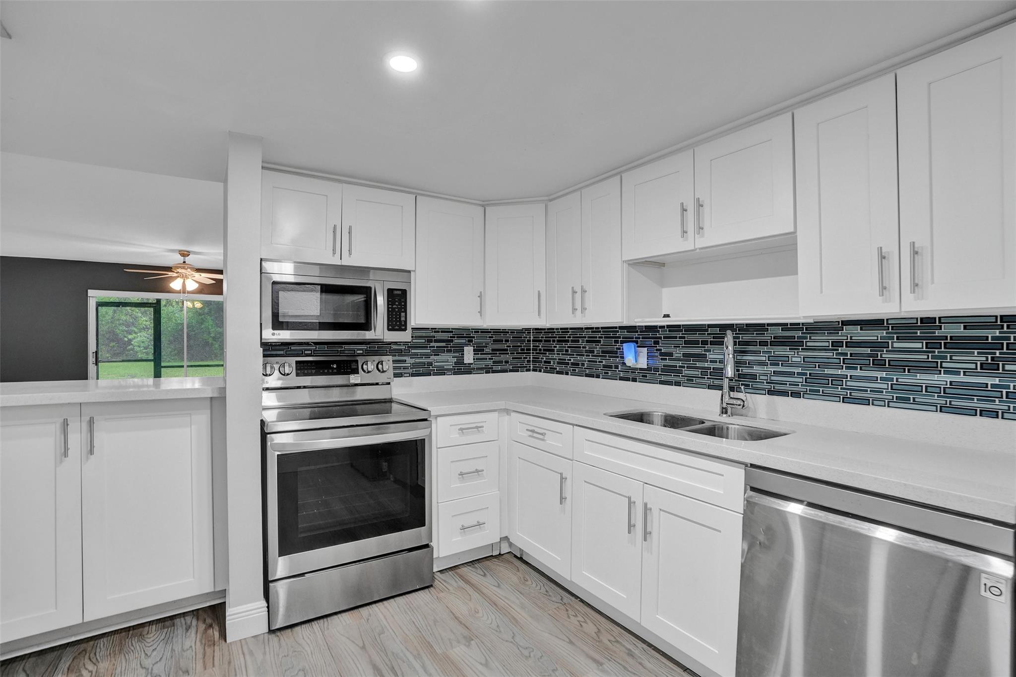 Beautifully updated 2-bed, 2-bath condo in the heart of Coral Springs, where every inch has been thoughtfully designed and impeccably maintained. When walking in, you’re greeted by luxury vinyl plank flooring, white shaker cabinets, and bright, modern LED lights that makes the kitchen shine. Both baths feature sleek vanities and marble-style shower walls. In-unit washer and dryer add convenience, while the screened-in patio invites you to sip your morning coffee or stretch out on the floating hammock and lounge like a lazy teenager on a summer day. The spacious primary offers en-suite bath and ample closet space for easy, organized living. Association allows rentals from day 1, so whether investing, looking for a first home, or down-sizing with class, you won't want to skip over this one.
