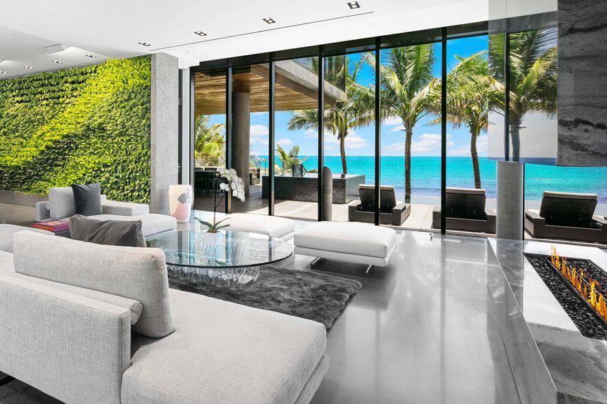 This exquisite custom-built oceanfront estate is a true masterpiece of modern luxury, designed to deliver a five-star resort lifestyle at home. Elevated 17 feet above sea level, it showcases 120 feet of direct ocean frontage and sweeping Atlantic views, offering a remarkable sense of exclusivity.
Spanning four levels and over 15,000 total square feet, the residence includes seven bedrooms, seven bathrooms, and two powder rooms—each space thoughtfully designed for comfort and elegance. A garage for six vehicles, private elevator, and expansive multi-level terraces enhance both functionality and the connection to the coastal surroundings.
A 3,000-square-foot rooftop sky terrace offers panoramic views, ideal for grand-scale entertaining or quiet relaxation. The second level features.. a striking infinity-edge pool and spa, seamlessly integrated into a fully renovated outdoor setting that maximizes views and tranquility.
Inside, refined finishes elevate every detail: lava stone floors and walls, a dramatic 1,200-bottle illuminated wine wall, and a living green wall that brings a bold organic element to the interior. The open-concept main kitchen is built for entertaining and complemented by a full catering kitchen to accommodate your private chef or larger gathering.
A private home theater and expansive, light-filled living spaces with refined architectural details offer both comfort and sophistication. The primary suite serves as a luxurious retreat, featuring a glass-enclosed office, gym, morning bar, and open-air Jacuzzi terrace. The spa-like marble bathroom offers dual vanities, soaking tub, and custom designer closets combining functionality with high-end style. An architecturally stunning outdoor staircase connects the pool level to a beachfront entertainment area, which includes a covered loggia, spacious beachfront turf-yard, and outdoor shower for effortless indoor-outdoor living.
Mature palms, lush tropical foliage, and artfully designed landscaping create a serene, private coastal oasis. At night, exterior lighting and fire features transform the estate into a glowing sanctuary.
Minutes from downtown Boca Raton, Delray Beach, and the Boca Raton Private Aviation Airport, this rare property is just 25 minutes from Palm Beach Island, home to world-class shopping and dining.
This exceptional estate exemplifies refined oceanfront living, offering unmatched privacy, sophistication, and lifestyle to the most discerning ultra-luxury buyer.