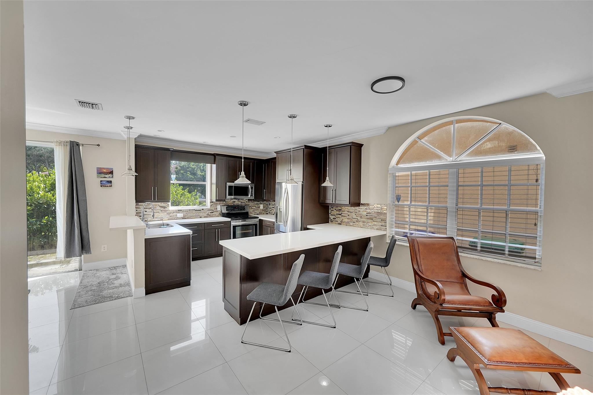 Exquisite Waterfront Home in Coral Springs- Fully Renovated! Step into luxury with this beautifully renovated 2-Story 3 Bed/2.5 Bath Waterfront Home. Modern upgrades & a custom chefs kitchen enhance its allure, while a newer roof, new A/C system & electric water heater provide comfort and efficiency. The arched windows, SS appliances & elegant porcelain tile flooring create a stylish ambiance throughout. The home also features high-hat lighting & a luxurious primary bedroom with a walk-in closet, dual sinks, and a separate shower and standalone tub for ultimate relaxation. Residents can enjoy the community pool, and the home's prime location offers easy access to transportation, shopping, dining, and more. Don't miss out- schedule a private tour today!