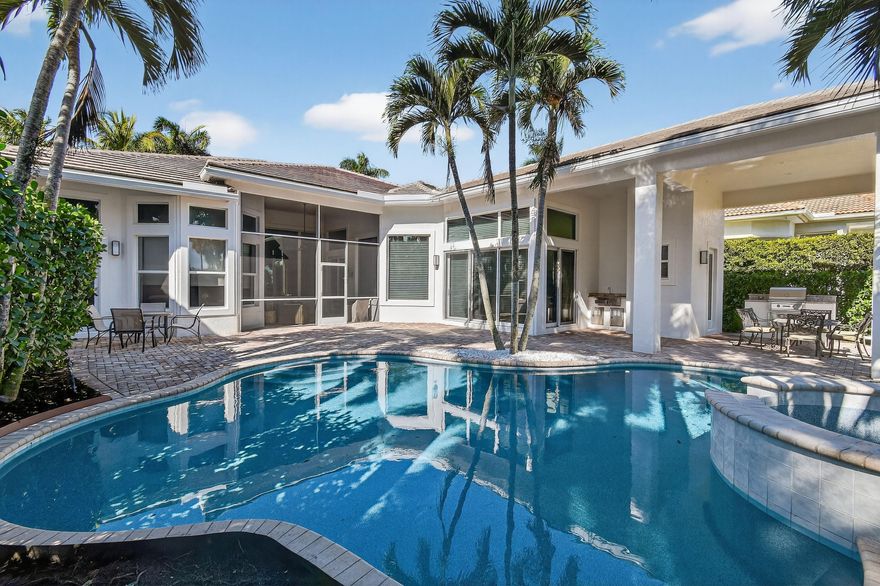 Within the prestigious, guard-gated community of Frenchman's Reserve, this elegantly reimagined single-story residence offers refined luxury, privacy, and timeless architectural appeal. Situated at the beginning of a quiet cul-de-sac on an oversized pie-shaped lot, the home enjoys expanded backyard space and tranquil golf and partial lake views across the 7th and 8th fairways, framed by mature landscaping and soft morning light. Offering more than 3,400 square feet of living space, the residence features three ensuite bedrooms, a dedicated office, and four full baths, all thoughtfully designed for both gracious entertaining and effortless everyday living. A grand foyer opens to expansive living and dining areas with soaring ceilings, elegant archways, marble flooring, custom millwork, recessed lighting, and a statement chandelier. Large windows fill the home with natural light while showcasing views of the pool, backyard, and fairways. These formal spaces transition seamlessly into the family room and the fully renovated chef's kitchen, appointed with quartz countertops, a substantial center island, custom paneled cabinetry, and professional-grade appliances including Sub-Zero and Thermador, along with a U-Line wine cooler and stainless-steel farm sink.

The bedroom suites are thoughtfully positioned for privacy. The primary suite offers serene views, direct pool access, generous walk-in closets, and a spa-inspired bathroom with dual vanities, a soaking tub, and a separate walk-in shower. Each guest suite includes its own private full bath, creating a luxurious experience for family or visiting guests. A fourth full bathroom, conveniently located near the main living area, also serves the pool and entertaining spaces.

The outdoor living environment is exceptional, featuring a screened and covered patio with an extended roofline, a heated saltwater pool resurfaced in 2026, and a summer kitchen with Sedona grill, ideal for elevated alfresco dining and entertaining.

Notable upgrades include a new roof (2025), impact windows and doors, a Sonos sound system, newer A/C units, EV charger, golf-cart parking and path, an expanded widened paver driveway, fresh exterior paint, attic storage, and garage cabinetry.

Residents of Frenchman's Reserve enjoy world-class amenities including an Arnold Palmer designed championship golf course, a grand clubhouse, fitness center, spa, tennis, dining, and resort-style recreation. A full golf membership is available, offering immediate access to the club's premier golfing and social amenities for those who desire the full lifestyle experience.