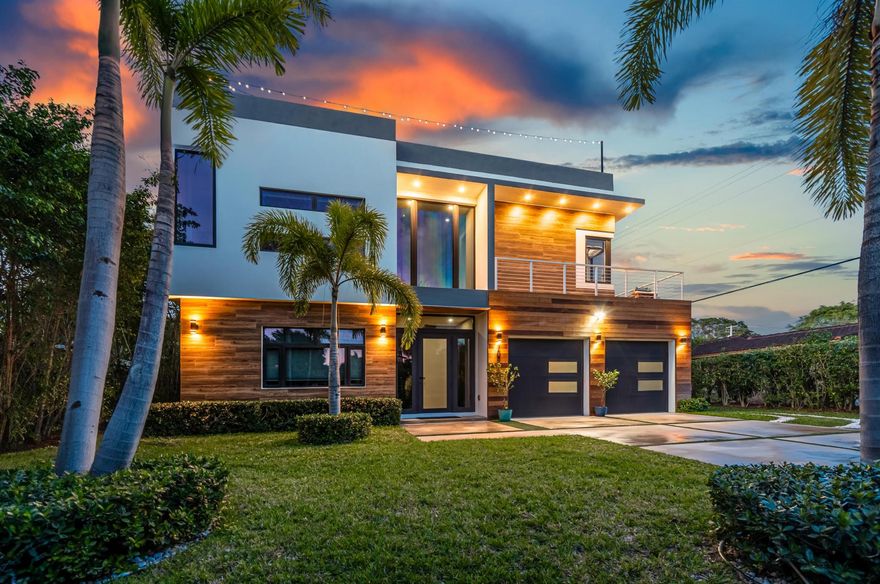 This is a modern residence styled for easy living, with an open floorplan, volume tray ceilings and over-size bedrooms that convey a sense of personal space. Concrete construction exterior walls, concrete first and second floors, impact windows and a security system proffer peace of mind. The 2,000+/- square foot rooftop lounge complete with wet bar and a 14' x 30' heated pool and garden patio assure ease of entertaining. Astro turf throughout the pristine tropical environ ensures a landscape easily maintained.