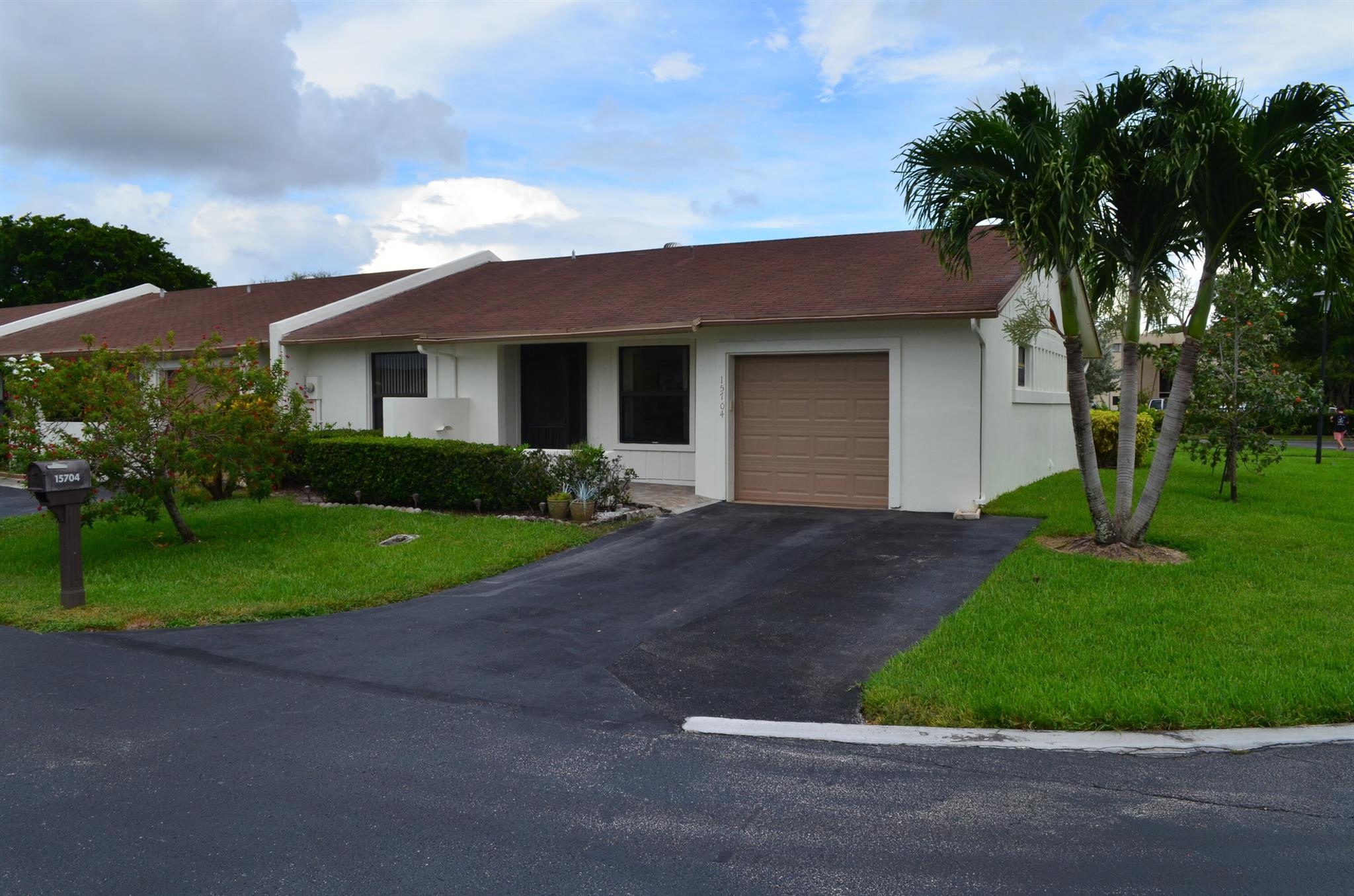 Absolutely stunning 2/2 End Unit Villa is completely remodeled w/ gorgeous open kitchen, level finished family room & newer bathrooms w/ Walk-In Showers in both. Kitchen is all redone with open concept to living/dining area, stainless appliances, Hi End Stone Countertops, tiled backsplash & softclose cabinets w/ a pantry and wine storage. Both bathrooms all redone with newer vanities, new tile, toilets and lighting. Bright clean tile on a diagonal throughout w/ plank tiles in the kitchen n baths. Full Hurricane Protection with all windows hurricane rated and shutter on front door. This villa has a newer roof (2019) & AC System (2019), tankless Water Heater and a double driveway for ease of use. Front n back patios. Exterior just painted by HOA. Fans in every room. See Supplement for more