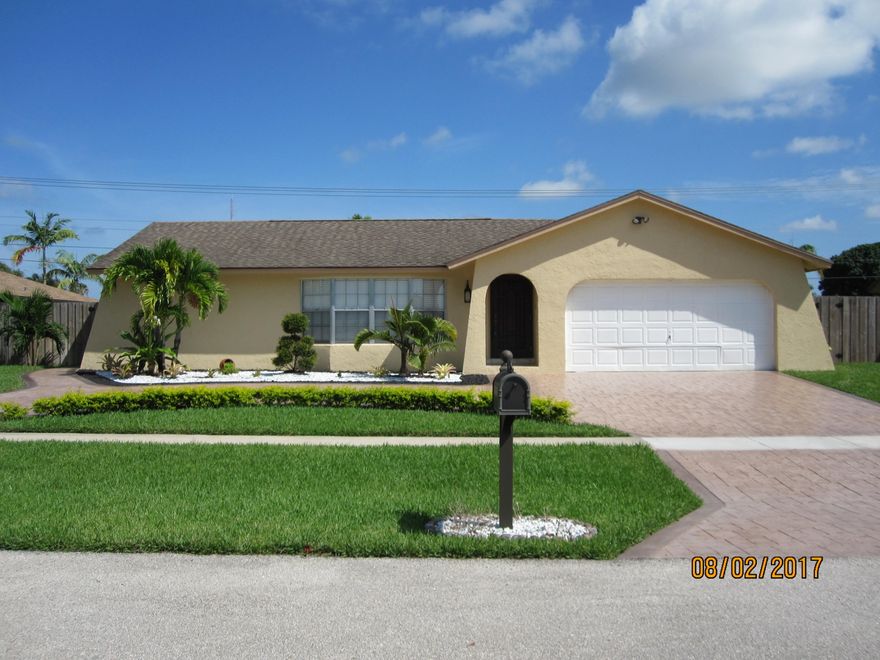 Rare opportunity to own this income producing home! Master Bedroom is converted to feature a bar-kitchen efficiency AKA Mother-in-Law suite. Separate entrance includes bedroom, bath & kitchenette, impact windows/door & a private courtyard. Main house has 2 bedrooms plus a den (4th bedroom) & cabana bath. Owner is willing to open the door to the master bedroom @ buyers request in order to have the efficiency part of the main home.  Home is immaculate & freshly painted. Front entry features a beautiful medallion inlay & new front doors. The circular drive way is accented w/ a beautiful Rock Garden. Interior boasts new 24'' flooring throughout, Den w/ Barn Door entry, new bedroom doors & High Hats thru out. 2012 AC. Sliders from Living & Family rooms lead to screened in patio & fenced in yard with Pool. Fully fenced in yard is nicely manicured and has Avocado and Hawaiian Banana Trees. There is a side yard with gate entry. The pool was recently refinished with Diamond Brite flooring, LED colored lights and New tiles. Home has a buried propane tank that is not currently being used. Shed does not convey. Great location in the heart of Wellington! Wellington School system, close to dining, shopping and entertainment. A short distance to highways and the Ocean.