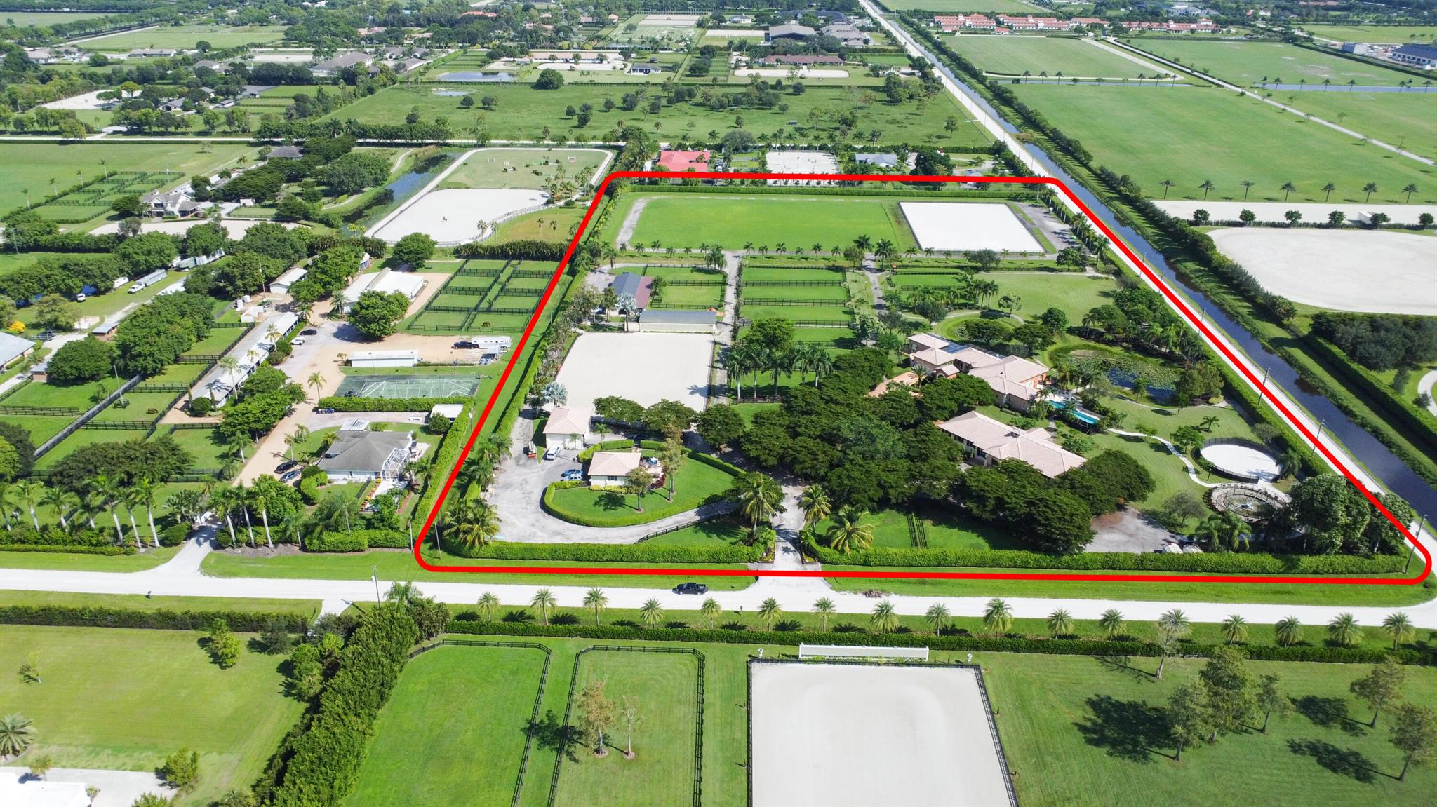 One of a kind stunning Equestrian Estate that makes you feel like you live in a resort. Nothing in Wellington compares to this beautiful farm. Set up for POLO, Hunter/jumper and Dressage, this 14.3 acre has 3 barns with 34 stalls, a Grand Prix ring, a Dressage ring with mirrors, a large stick/ ball field for Polo or as a Grand Prix grass ring, and plenty of room for a covered arena . Tons of paddocks with new fencing, main house has 4 bedrooms with an additional 2 bedroom grooms home. Huge pool area and additional oversized garage for equipment. This dream farm will not disappoint