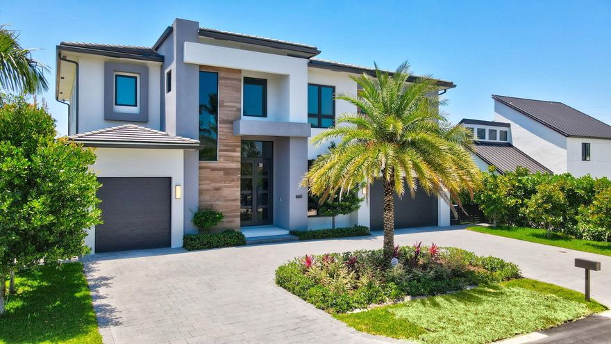 PRICED TO SELL !! OWNER PURCHASED LARGER HOME -MUST SEE!! LOCATION!! LOCATION!! LOCATION!! This Modern Estate was built by Premiere Builder, ''Elysee Homes'' You will be in Awe of this architectural masterpiece with Waterfront living unlike no other on canal going directly into the beautiful Intra Coastal (5 homes from the Pointe). Features include: 5 En-Suite Bedrooms Den/Office/Club Room 5 Full Baths 1 1/2 Bathrooms - (3) Garages, Quartz Countertops Italian Porcelain Tiles 48X48 2nd Level - Engineered Hardwood 12 Ft Ceilings 10 Ft Front Door Full House Generator Elevator Outdoor Kitchen More... WATER BOCA ESTATEBring your Yacht and Walk to the Beach from this south facing (in the rear) NO FIXED BRIDGES-20,000 lb boat lift.