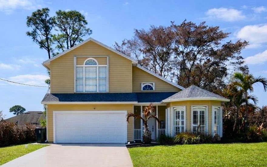 Beautifully updated pool home in the heart of Port St. Lucie! This spacious 3-bedroom, 2.5-bath residence showcases quality upgrades and stylish finishes throughout. The designer kitchen is a true standout, featuring rich wood cabinetry, a custom tile backsplash, granite countertops, and top-of-the-line appliances. Additional enhancements include updated ceiling fans and light fixtures, upgraded bathroom mirrors and hardware, and elegant plantation shutters throughout the home. Step outside to your extended patio and private pool area, perfect for relaxing or entertaining. Accordion shutters provide added hurricane protection and peace of mind. Plus, the home is equipped with solar panels, helping you enjoy impressively low monthly electric bills and energy savings. Roof installed 2023. This move-in-ready home combines comfort, style, and efficiency, all in a prime Port St. Lucie location.