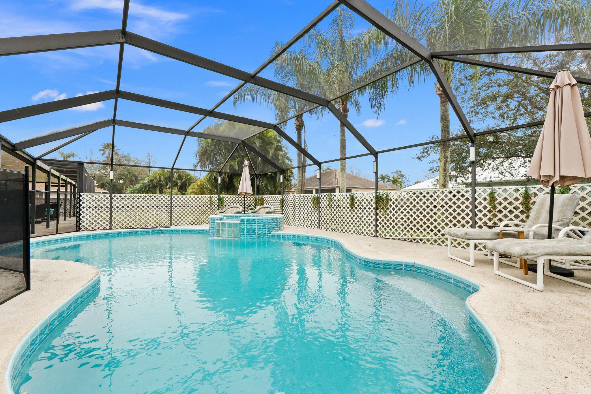 Your Port St. Lucie Pool Paradise Awaits! Dreaming of space to breathe, a backyard to live out loud, and a home that loves your four-legged family just as much as you do? Welcome to your next chapter! This spacious 4-bed | 4-bath | 2-car garage home is set on a rare HALF-ACRE lot--fully fenced to keep your pups (and people!) safe and free to roam. Dive into the Florida lifestyle with your private screened-in pool and sprawling patio, perfect for hosting everything from cozy hangs to big celebrations. Inside, you'll find durable tile flooring throughout (because life's too short to worry about spills!), an inside laundry room that actually makes laundry day a vibe, and a bright kitchen with stainless steel appliances and crisp white cabinets ready for your personal flair.