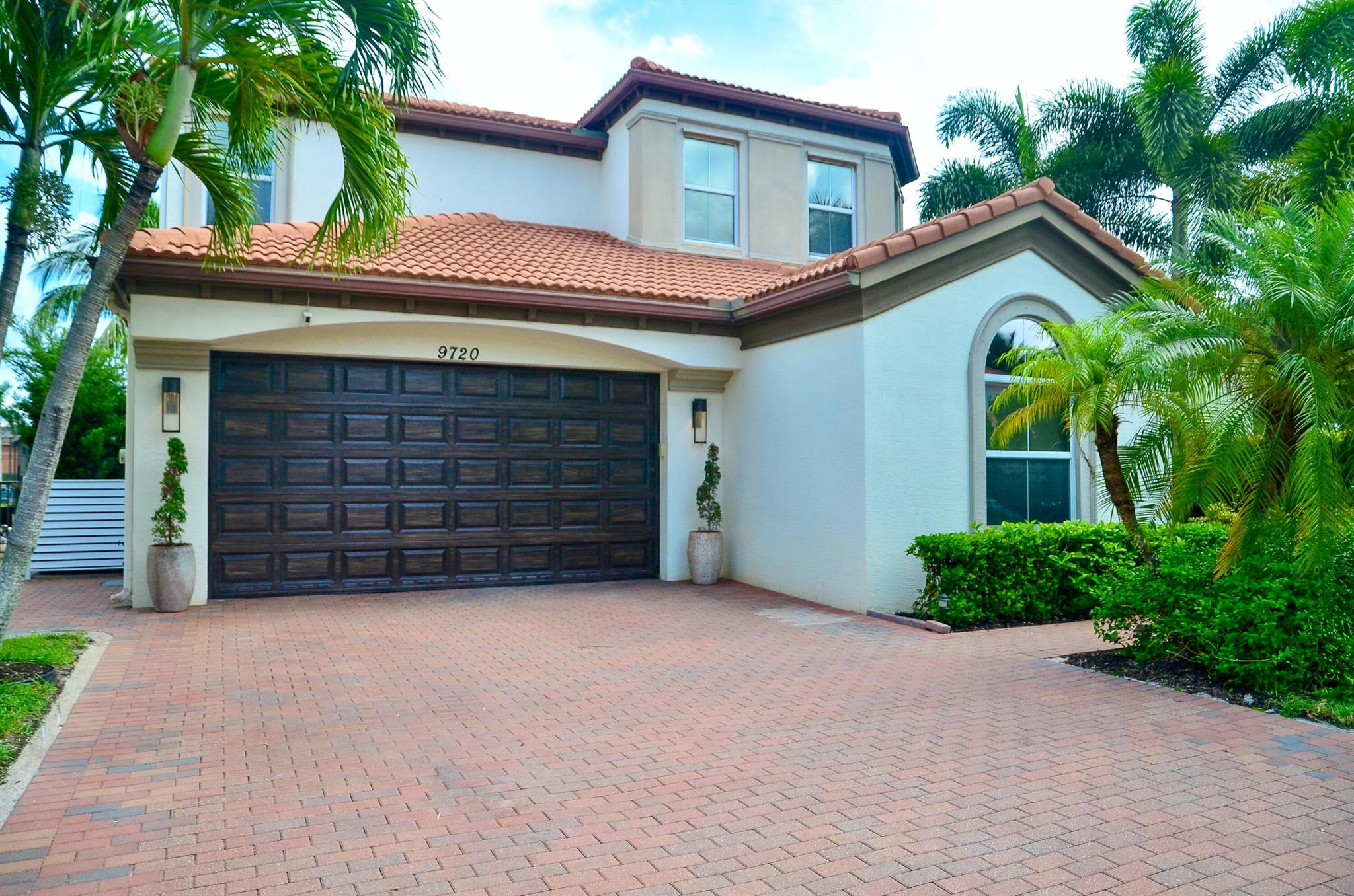 Welcome home! Just remodeled waterfront 5 br + office cul-de-sac home, huge yard in Wellington's sought after Olympia community. First floor boasts a large format porcelain tile with upgraded kitchen, new quartz counters, backsplash, and plumbing fixtures. Open concept kitchen overlooks family room with an accent board and batten wall and plenty of light. One bedroom and full bath downstairs and half bath perfect for guests and entertaining. Dark wood spiral staircase leads upstairs to 3 bedrooms each with own bath and flex office space. Custom closets throughout and a showstopper primary bath with all brand new vanities, floors, shower glass and a free standing oversized soaking tub! Expansive primary closet and balcony with wood ceiling accent and an oversized backyard with fruit trees