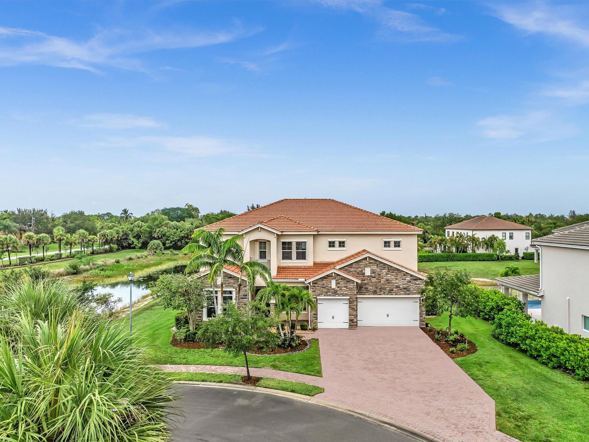 Elevate your lifestyle in this breathtaking estate, boasting nearly 5000 square feet of living space on an exclusive 19-home community. Enjoy serene lake views, a picturesque water fountain, and high ceilings, perfectly complemented by custom marble flooring, coffered vaulted ceiling, and gourmet chef's kitchen. With two master suits, an expansive upstairs living area, and an office, this stunning property offers the ultimate retreat. This home sits on almost quarter acre land and ideally located near the world-famous Wellington polo club, upscale shopping and dining, as well as the expansive Okeeheelee Park and highly rated Palm Beach Central high school, this luxury residence embodies the essence of refined living.