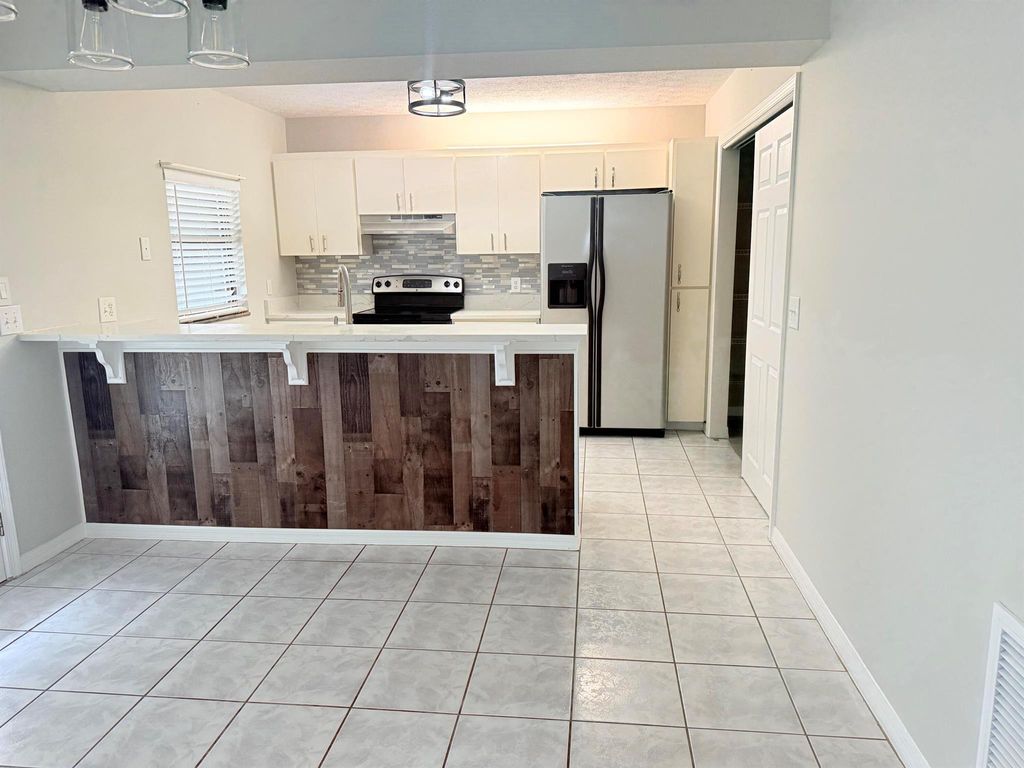 Photo of 1355 SW Granville Avenue, Port Saint Lucie, FL 34953 (MLS # R11073830)