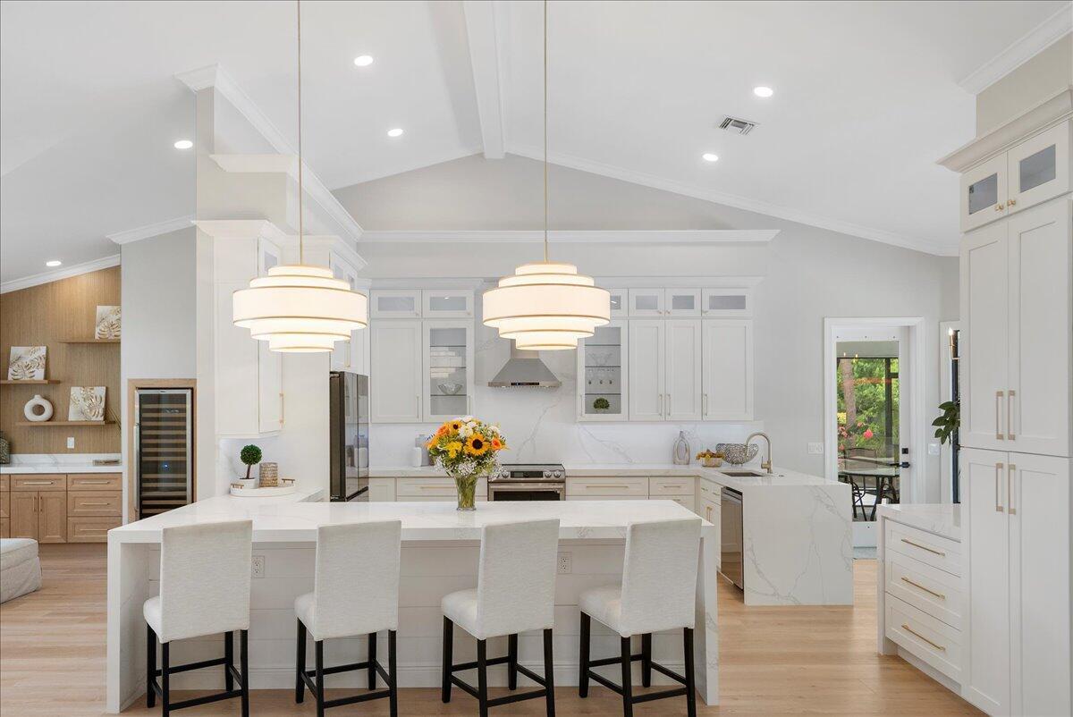 Looking for luxury, elegance, and comfort? Discover this move-in ready 4BR/3BA/2.5-car garage Palm City pool home on 1.16 acres. Designed with style and upgrades throughout--fine finishes, custom millwork, crown moulding, feature walls, and solid core doors. Perfect for entertaining, the expansive interior offers a gourmet kitchen with quartz waterfall peninsula, coffee bar, and wine bar. Multiple living areas flow to a screened porch overlooking the modern pool and lush landscaping. The primary suite features dual walk-in closets and a spa-like soaking tub. Additional bedrooms are ideal for family, guests, or office space. Extras include a whole-house Generac generator and spray foam insulation.
