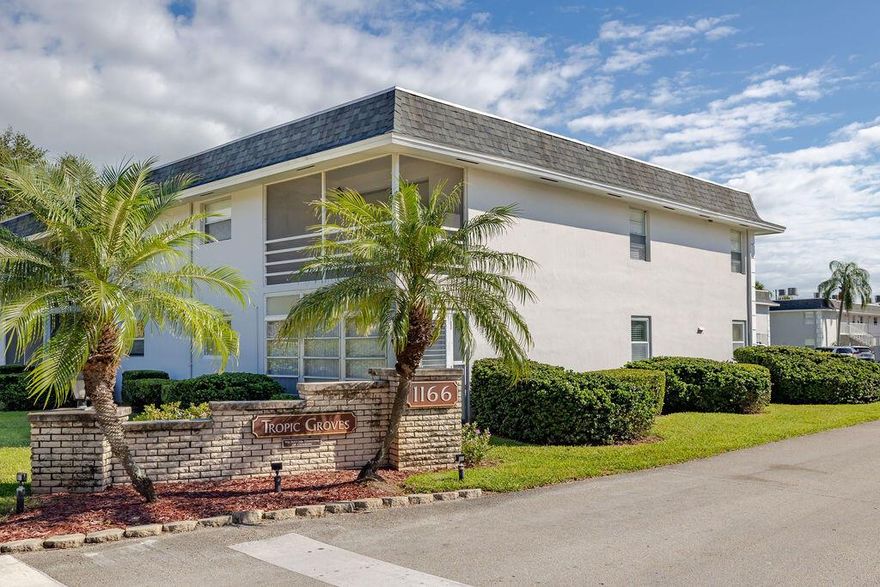 This 2-bedroom, 2-bath ground-floor corner condo (Unit A-1) offers easy access to everything--just minutes from shopping, grocery stores, hospitals, movie theaters, and the beach. Ideally situated next to the pool and clubhouse, this home provides comfort and convenience in one perfect package. Features include impact hurricane windows, tile flooring throughout, two walk-in showers, a tankless hot water system, appliances just a few years old. The sunroom, accessed through sliding glass doors, offers versatile space for a TV lounge, reading nook, or storage, and includes an exterior door leading to a grassy area for added ease.