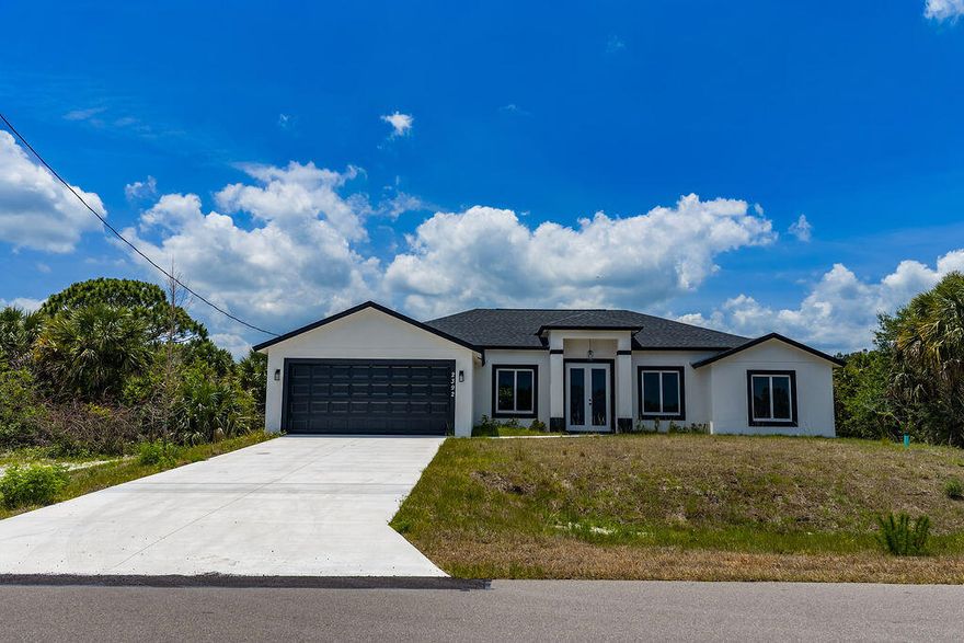 Beautiful brand-new 4BR/3BA/2CG home with over $50K in upgrades! Features high ceilings, coffered ceilings in the great room & primary suite, open floor plan, tile throughout, granite countertops in kitchen & baths, farmhouse sink, stainless steel appliances, impact doors & windows, and a spacious back porch. Primary suite offers a luxurious shower & Jacuzzi tub. Located in a great neighborhood with good schools and close to shopping, dining & more. A must see! Adjacent vacant lot at 2376 Madden Ave is included 1/4-acre lot (Folio #29-36-26-KS-02592.0-0024.00).