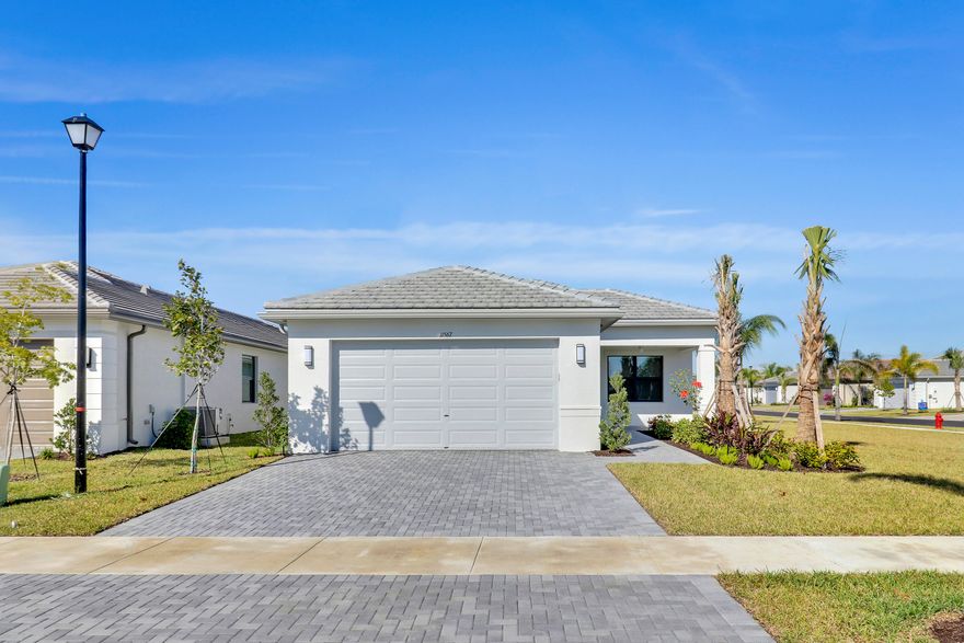 Welcome to this beautifully maintained newer construction home in the desirable Riverland community of Port St. Lucie. Built in 2024, this spacious residence offers approximately 2,136 square feet of living space with a thoughtful open layout designed for comfort and modern living.  The home features 3 bedrooms, 3 bathrooms, and a bright open-concept living and dining area that flows seamlessly into a stylish kitchen with modern finishes and ample cabinet space. Large windows bring in natural light throughout the home, creating a warm and inviting atmosphere.  The primary suite offers generous space, a private bathroom, and excellent closet storage, while the additional bedroom is ideal for guests, a home office, or flex space.
