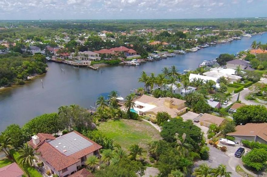 Build your dream home or two units with the possibility of three units on this elevated Intracoastal lot. Zoned multi-family The views are spectacular and this section of the waterway is a no wake zone. There is 105 feet of water frontage with a depth of 165 feet for a total of .35+/- acres. Water and sewer are at the site and there are building credits that are transferable to the buyer.  The existing dock has two boat lifts (16,000 LBS & 12,000 LBS) or you can reconfigure for a large yacht. Convenient boat launching available at Juno Park or Bert Winters Park just to the north on Ellison Wilson. Existing survey can be viewed under documents. The house was torn down and additional fill was brought in. This ready to build lot has a 11' elevation. Don't miss out on this opportunity.