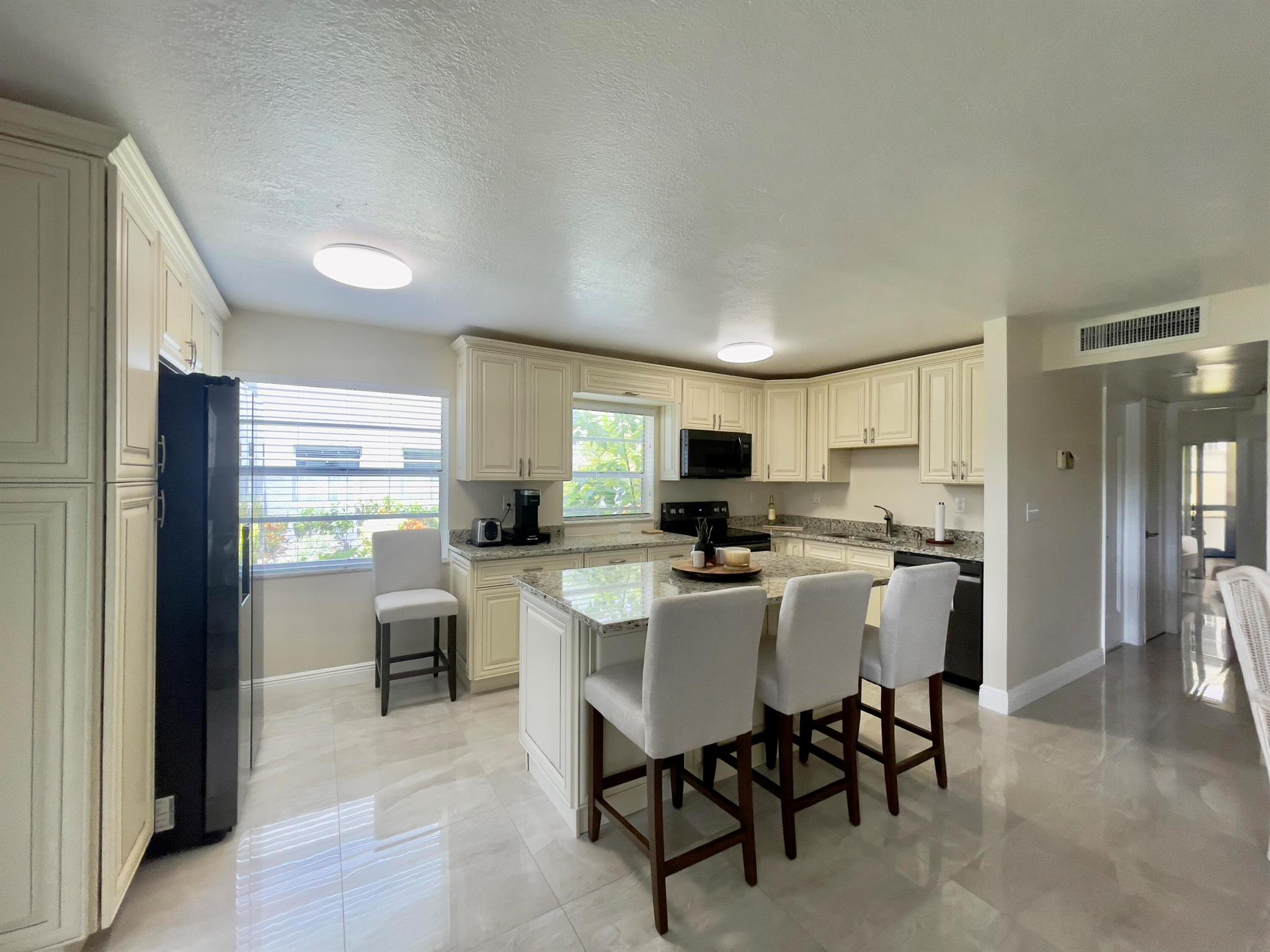 Beautiful First Floor Remodeled condo. 2 Bedroom , 2 Bath. Gorgeous kitchen with real wood soft close cabinetry, Stylish Island, Great storage & Pantry space. Granite counters w/modern appliances. Porcelain tile floors. Completely updated bathrooms & relaxing enclosed Patio space..New Plumbing, & New electrical. This is a beautiful unit in a great location and terrific value.