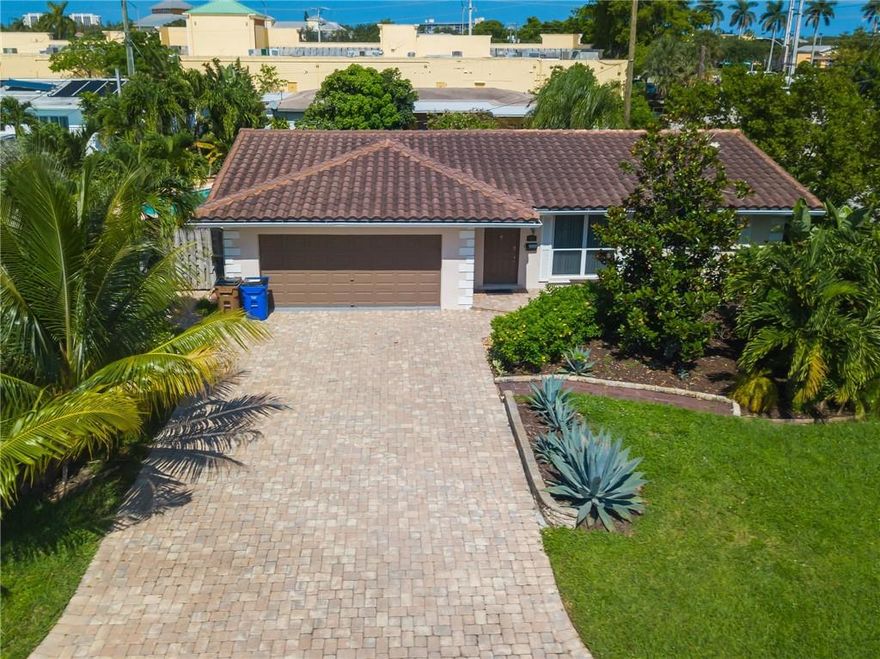 Tropical Florida Paradise in this over-sized 2/2 with an Florida room that could easily be converted into a 3rd bedroom. The heated pool is lushly landscaped with beautiful palm trees and several outdoor seating areas to enjoy all the Florida lifestyle has to offer. This home features over 1900 sqft under air with a large laundry room with built ins and an additional refrigerator. Both bathrooms and kitchen have been updated with neutral tile throughout.  Furniture is negotiable. Currently being used as a short term rental.