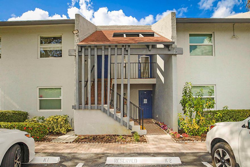 Beautifully updated with peace of mind built in -- this 55+ home features all impact glass windows plus roll-down shutters on the back patio. Inside, enjoy quartz countertops, shaker cabinetry, stainless steel appliances, a new stackable front-load washer and dryer, wood laminate flooring, updated bathrooms, and a new AC. Relax with a peaceful garden view in a well-maintained community with no special assessments.