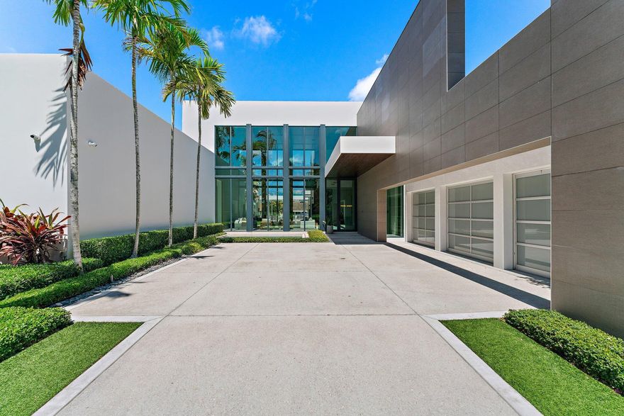 A Masterpiece of Modern Luxury, this residence represents International Style architecture at its finest, defined by clean lines + organic materials. Outstanding Admirals Cove location on coveted Spyglass Lane, just steps from the wide Intracoastal Waterway. Nestled on .49 scenic acres between golf course + 100'  Waterfront, this home elevates living with every detail crafted to perfection. The striking facade merges modern precision with enduring quality + durability. Step inside to a grand open space graced by double height walls of glass. Interior space offers several living/gathering areas, perfect for entertaining or quiet enjoyment. The contemporary chef's kitchen features Italian cabinetry + backlit cristallo counters. Highest end appliances and a butlers pantry finish this perfect  space. Beyond the kitchen is an elegant family room as well as a generous recreation area, complete with bar and a state of the art golf simulator.  The secluded Owner's suite is serene + tranquil with its own spa inspired bath and stylish wardrobe room.  An additional downstairs bedroom and three upper guest rooms are all grand in size and thoughtfully designed.  The upper level living area is perfect for guests.  From the moment you enter this home, you will be touched by thoughtful design sophistication - inside + out.  The outdoor areas areas bask in verdant greenery.  The pool + surrounding areas are a breathtaking oasis of comfort + luxury.   A sauna bath and outdoor fireplace enhance the oversized spa + lap pool.  Upper and lower sun decks provide great space for enjoying fine Florida living. For Boaters: New deck + dock w/ 16,000 lb lift ... Easy Intracoastal + Ocean Access with No Fixed Bridges.   An air conditioned 3.5 car garage + spacious outdoor motor court offer added convenience.  The Admirals Cove Club is one of the most secure and prestigious in all of Florida, offering 45 holes of golf, two grand clubhouses and a world class marina with floating docks.  Both clubs offer exquisite dining experiences as well as rooms for private functions.  A separate building houses the state of the art fitness center and full service wellness spa.   Tennis + pickleball enthusiasts will always find an open court.  Additional amenities include a kids club, dog park, salon, bank and the private Admirals Cove hotel reserved for members and their guests.  Outside the gates, you are just minutes away from the areas best beaches, shopping, dining, educational + cultural venues.  25 minutes to Palm Beach Island or the PB Int'l airport.  A beautiful lifestyle awaits you...