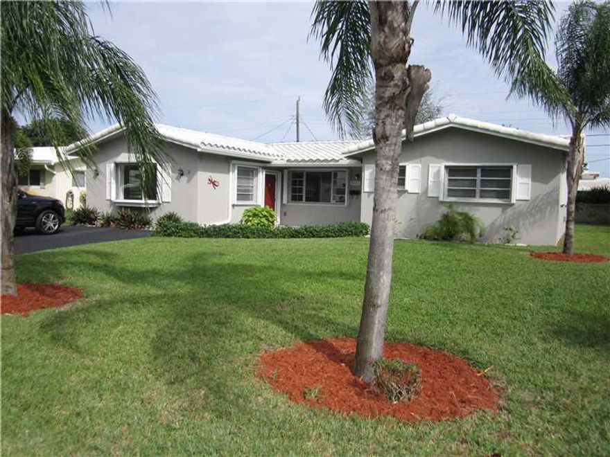 Newly remodeled 3/2 on a quiet street in Coral Ridge Isles. This home boasts new kitchen with island, new stainless steel appliances including gas range, open floor plan with laminate floors throughout, remodled baths and a huge family room. French doors  lead to fenced-in yard. Home has new roof, new A/C, freshly painted, and the owner will be installing hurricane shutters. Excellent home with a bright open living area on a quiet street.