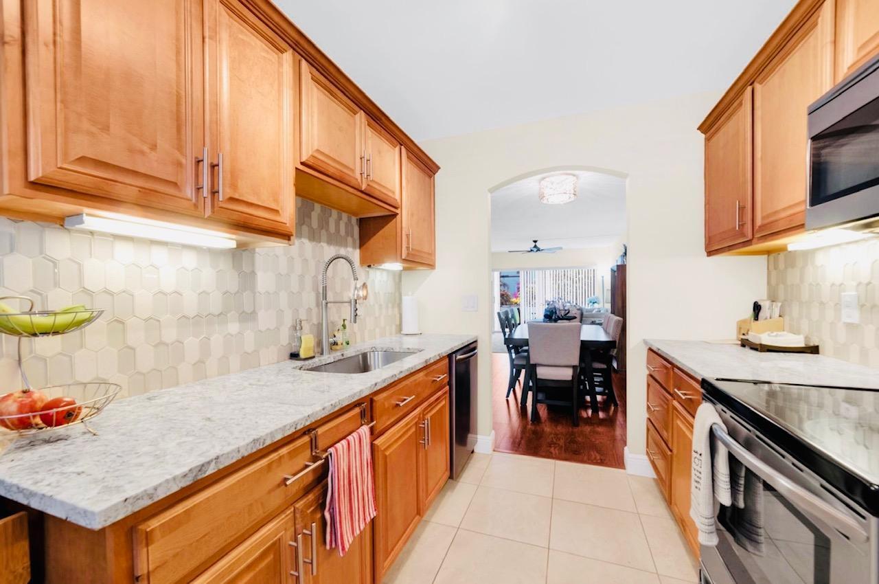 55+ Do not miss this completely renovated 2/2 ground floor unit, engineered wood floors, stainless steel appliances, patio exterior sliding glass doors, impact windows, plantation shutters, accordion shutters. Free basic cable, internet and water. Free laundry machines on each floor. Sabal Pine Cond is closed to i95 access, Tri-Rail station, shops, grocery stores, excellent LOCATION! 2.5 miles to the Beach, 10-15 minutes to trendy Downtown. Assigned Parking by your front door!