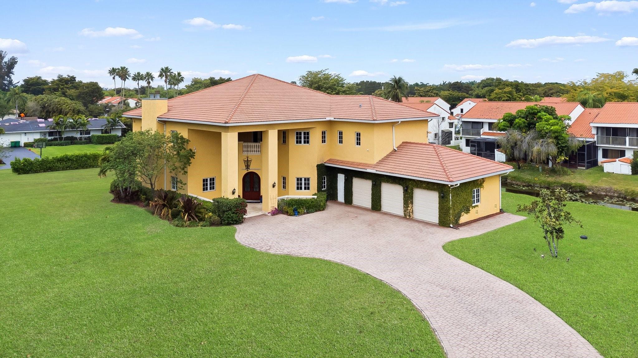 This home, lovingly maintained in pristine condition by its original owners, is now available for its first resale since construction! Offering luxury and convenience, you'll find striking oak wood doors & banister with a winding staircase, a primary suite that features a private balcony & walk-in closets. Other notable features include high-end custom finishes, Pella impact windows, tankless water heater with recycling pump, central vac, 23-ft ceilings, & R30 insulation for energy efficiency. The backyard offers potential for a custom pool, outdoor kitchen, tennis courts, or horse stalls. Ideally located near I-595, I-75, & the Sawgrass Expy, commuting is easy.A true gem, blending modern amenities with timeless elegance.