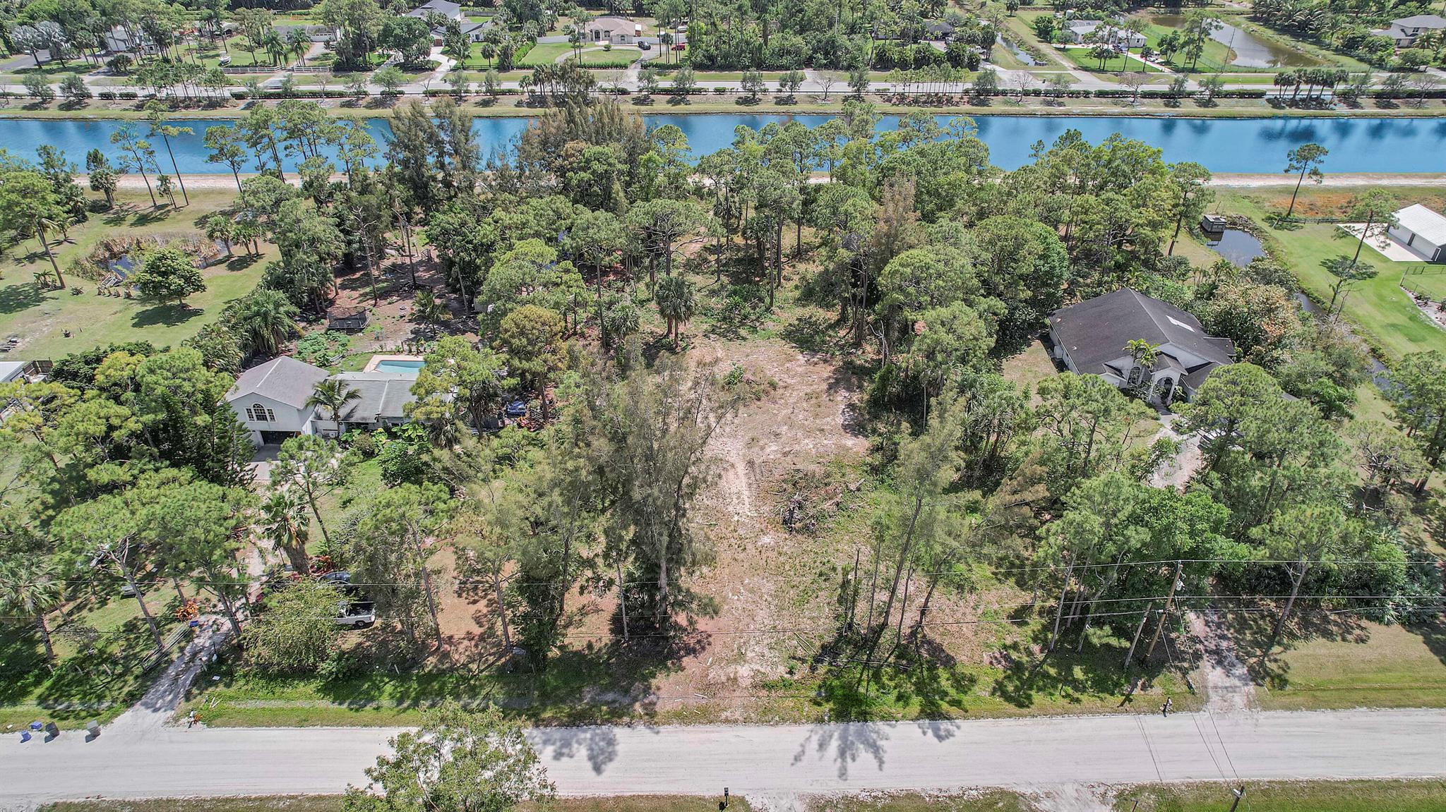 Beautiful high and dry lot with an abundance of pine trees throughout in a quiet neighborhood. House pad fill already on lot and backs up to a wide canal. Easement off canal at rear of property adds Sq footage to lot. Build your dream home with a beautiful waterfront view. Please feel free to walk the property.