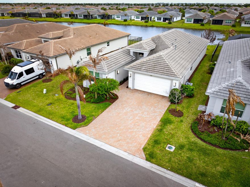 Welcome to this beautifully upgraded lakefront Bimini model in Riverland, offering the perfect blend of luxury, comfort, and true move-in-ready convenience. This 3 bedroom, 3 full bathroom home plus a versatile den is being sold fully furnished, making it an exceptional opportunity to step right into the Florida lifestyle without the time, cost, or stress of building. Positioned on a premium lakefront lot, the home features peaceful water views and a backyard designed for entertaining, complete with an extended screened lanai and a fully equipped outdoor kitchen with a grill, wine fridge, and ample counter space.  Inside, the open concept layout is centered around a bright, spacious kitchen with upgraded cabinetry, quartz countertops, a large island with seating, stainless steel  appliances, a designer backsplash, and a stainless steel hood. The primary suite offers a relaxing retreat with a tray ceiling and a fully customized walk-in closet, while the flexible den with a Murphy bed and closet can easily function as a fourth bedroom or home office. Additional upgrades include tile flooring throughout, crown molding, remote control blinds, upgraded lighting, and enhanced bathrooms with tile extended to the ceiling. The finished garage features epoxy floors, built-in storage, a utility sink, EV charging outlet, and a golf cart garage. With over $94,000 in builder upgrades and extensive post-closing improvements, this home offers a level of finish and value that is truly better than new.