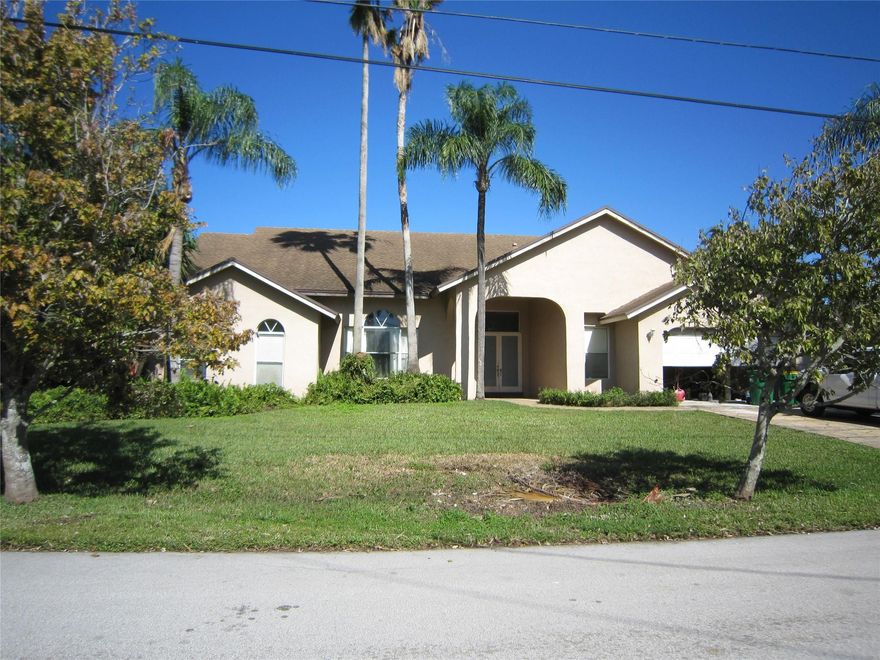 Spacious custom built 4/3 1/2 with over 3000 sq ft of living area custom.  Plantation north acres diamond in the rough, high volume ceilings, laundry room, needs to be refurbished from ceilings to flooring. Roof replaced in 2017, one A/C in 2017.  Best yet there is NO HOA!