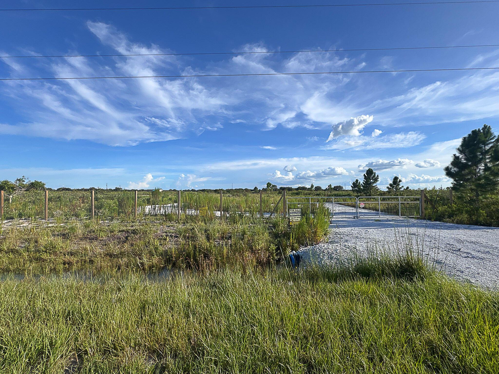 Discover the perfect blend of tranquility and opportunity on this stunning 1.25-acre parcel of vacant land, ideally situated for your single family or mobile home. This property offers a unique chance to embrace the serene beauty of country living, while still being conveniently located just 35 minutes from the vibrant heart of downtown Okeechobee and the sparkling shores of Lake Okeechobee. Key Features: Recent Full Survey: The land has been meticulously surveyed, ensuring a hassle-free development process for your single-family home or mobile home. Access and Infrastructure: Enter through the newly constructed roundabout driveway with a culvert, leading you to a secure front gate and a fenced front perimeter that provides privacy and peace of mind. Ready for Development: The property is