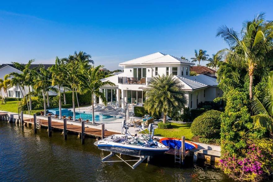 Bright and airy, the custom built residence at 33 Ixora Way in Ocean Ridge offers 95 feet of waterfrontage, dock and private beach access. The four bedroom home offers an open floor plan with numerous sliders and windows to showcase the picturesque views of the grounds and waterway. Features include gourmet kitchen, first floor master suite, upstairs loft and three additional guest bedrooms. Enjoy outdoor entertaining with summer kitchen, pool with spa, expansive patio and private beach access. Boaters will appreciate the 75-foot dock and nearby ocean access. Conveniences include full-house generator, impact glass, Smart house technology, two car garage and large attic. Custom built with the finest finishes this coastal home is the perfect place to enjoy the South Florida Luxury Lifestyle.