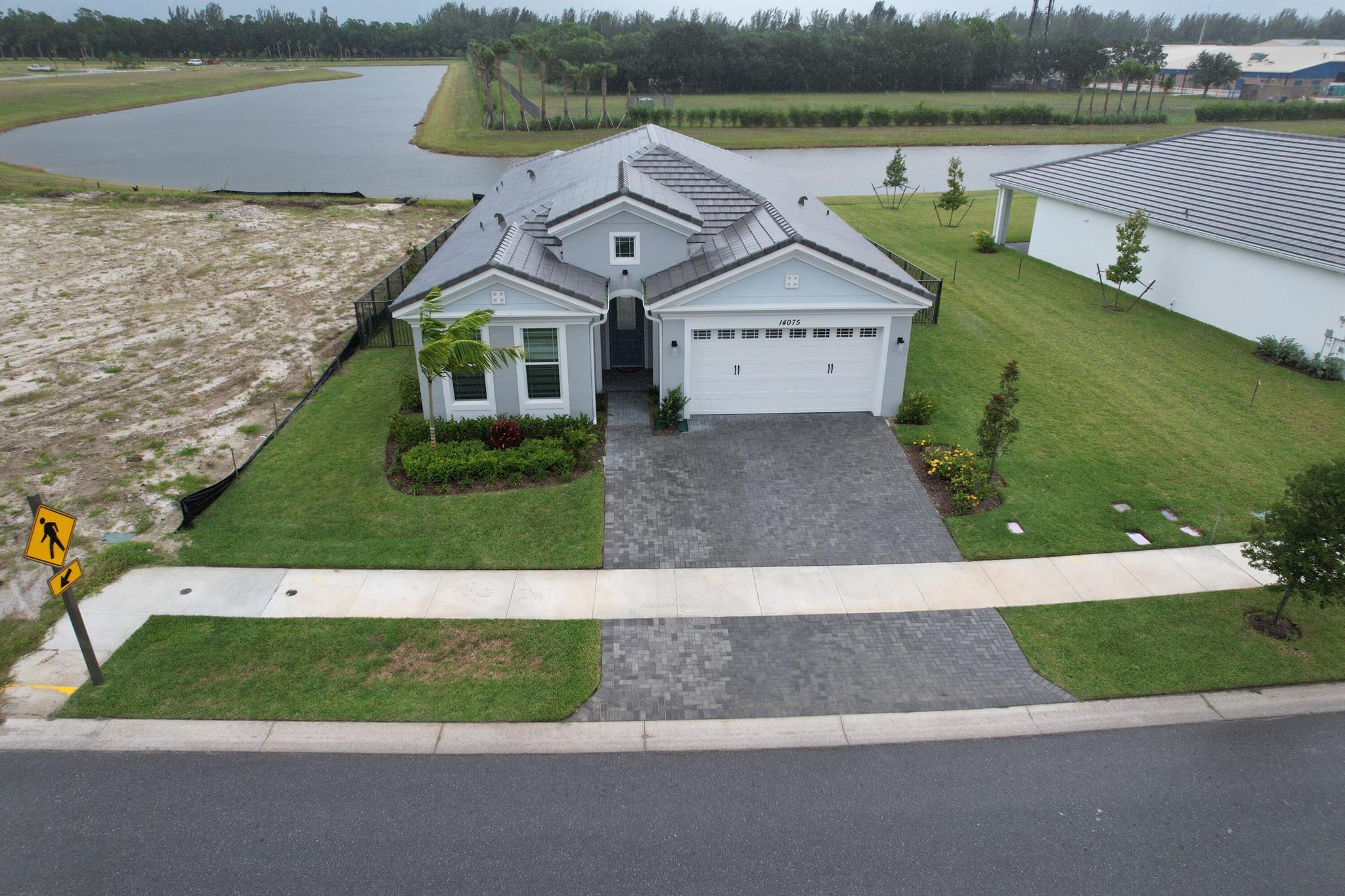 Beautiful 3 Bed, 2 Bath Home in The Pines of Westlake! This single-family home features an extended paver driveway, a spacious patio with canal views, and no rear neighbors. Enjoy year-round breezes, shaded backyard living, and the privacy of backing up to the elementary school. Located in the heart of Westlake with access to golf cart trails, a resort-style water park, and family-friendly amenities. Schedule your showing today! See the virtual tour for detailed interior photos.