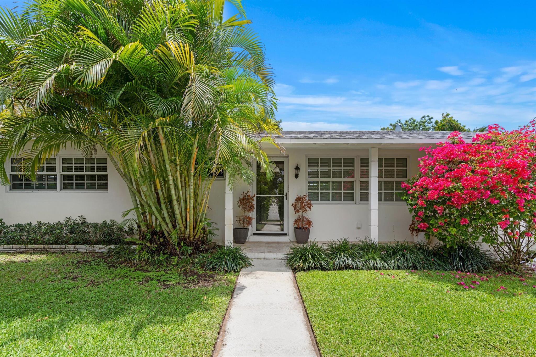 Nestled in the coveted College Park neighborhood, this charming, move-in ready 3-bedroom, 2-bath residence boasts coastal living at its finest. The home offers two en-suite bedrooms, plus a versatile bonus room, which can serve as a third bedroom, office, or gym. The bright living room overlooks the pristine backyard, providing a serene view with ample natural light. The private backyard features lush landscaping, a covered patio with a retractable awning, and an immaculate pool. Just one block south from SOSO neighborhood, this charming jewel is conveniently located near West Palm Beach and Downtown Lake Worth.