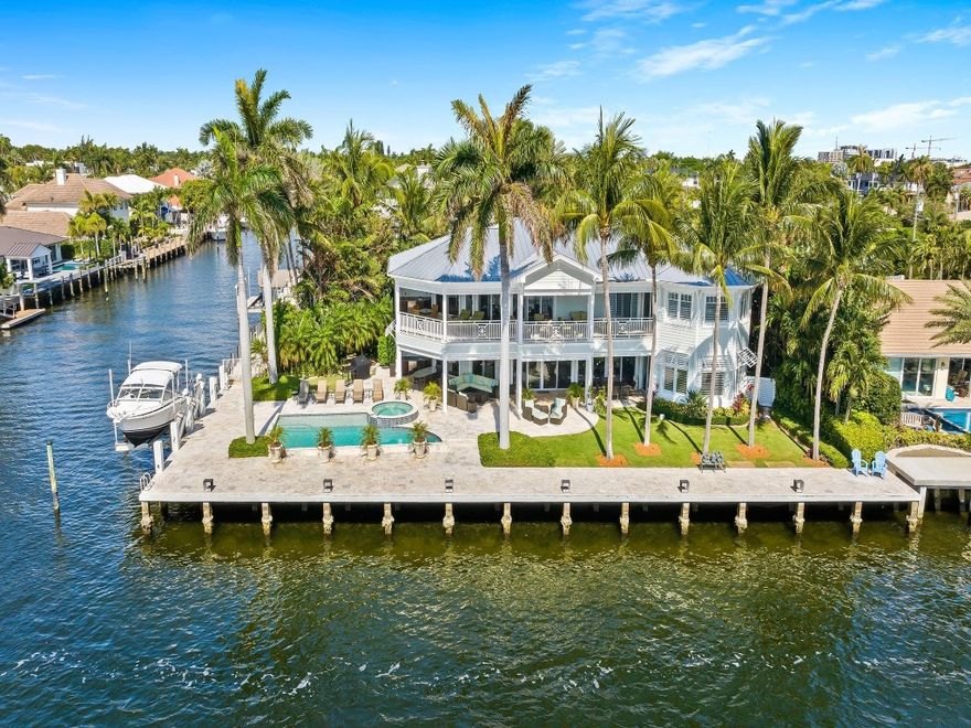 Exceptional SE point lot boasting approximately 174 ft of waterfront along the Intracoastal waterway & side canal w/a parade of boats & breathtaking views. This waterfront estate is a masterpiece in design & curated finishes. The open concept floor plan & multiple living spaces maximize waterway views. Sliding doorways extend interior living & entertaining areas to the tropical expansive covered terraces, balcony & patio area. The kitchen & pantry will inspire those who cook & entertain while overlooking the waterway. The lavish primary suite offers a lrg walk-in closet & spa inspired bathroom. All 2nd floor bedrooms are ensuite with access to the expansive waterside covered balcony. This home offers an elevator, 1st & 2nd flr laundry rms, home generator, boat lift & more. Sq ft from IMAPP