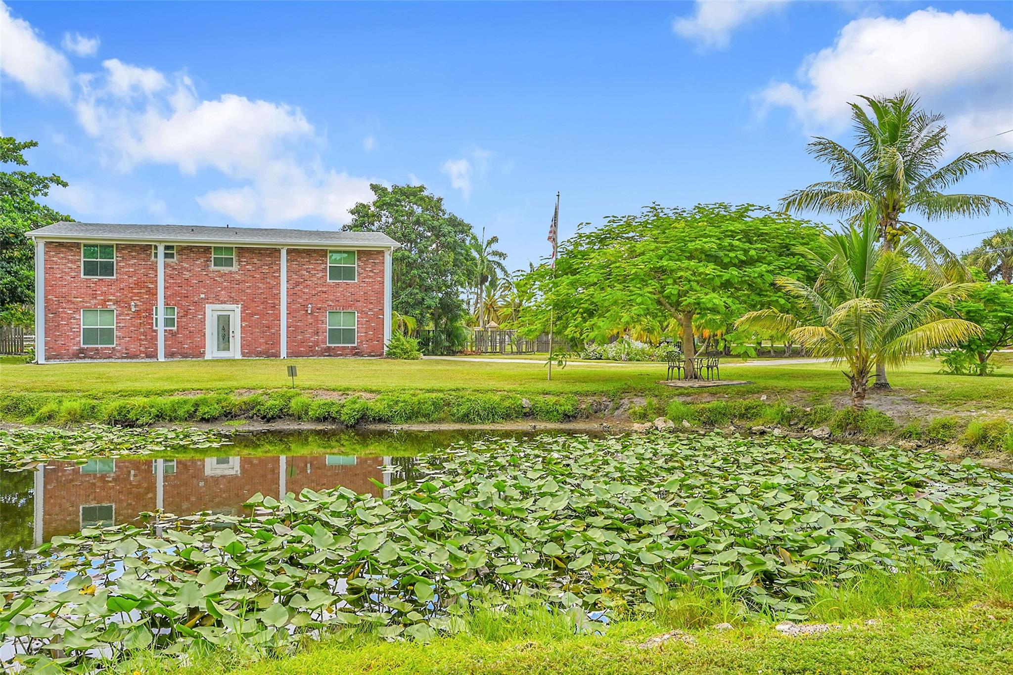 Discover this stately 2-story Colonial in desirable Plantation Acres. Set on 2+ serene acres with no HOA, this brick-faced home offers privacy, land and charm. This home can be rented furnished or furnished. 4 bedrooms, 2.5 baths, and spacious living areas. Plenty of parking, shed for extra storage. Attached studio available for rent for $1200. Great location-minutes from shopping, dining, and major highways.